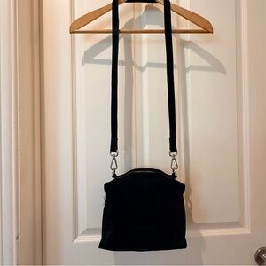 Urbancode London Black Suede crossbody bag with top handle.
